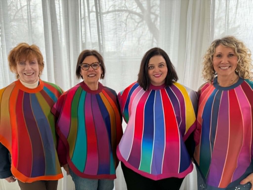 Four women wearing colorful draping capes during a color analysis party experience with Royanna Stratmoen of Radiate with Royanna