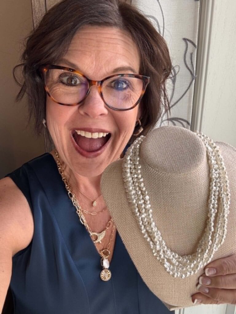 Royanna Stratmoen holding a Park Lane Jewelry necklace display — accessories that make every outfit sparkle
